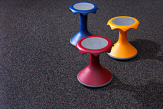 Children's recreation chairs rest on REGUPOL aktiv flooring at Horsham Athletic Club. The floor has a unique blend of colors that promote the overall brand identity of the facility.