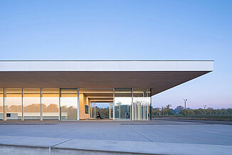 Side view of the Neil Campbell Rowing Centre facility, showcasing the innovative glass walls and design.