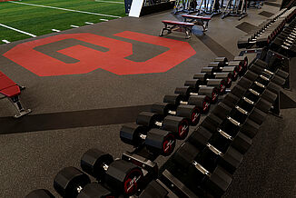 Oklahoma University Weight Training - Free Weights Area REGUPOL aktivpro roll flooring demonstrating customizability at Oklahoma University with the inlaid logo and free weight section located nearby.