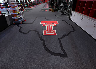 Texas shaped Texas Tech logo that showcases team dedication and pride upon entering the Olympic training room.