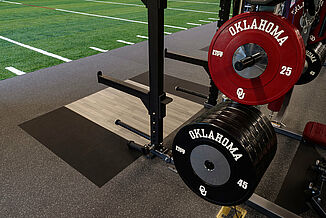 Oklahoma University Weight Training - Weight Rack and Platform Turf and REGUPOL aktivpro roll flooring with a weight rack and platform at Oklahoma University