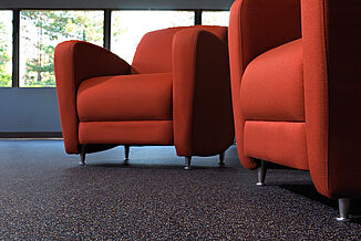 Recreation and reception area chairs rest on REGUPOL aktiv flooring, allowing for a seamless floorplan through reception areas and fitness center areas.