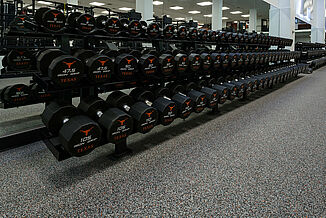 University of Texas at Austin Weight Training - Dumbbell Rack View of the dumbbell rack offered to athletes at the University of Texas at Austin weight training facility. The rack rests atop REGUPOL aktipro roll flooring.