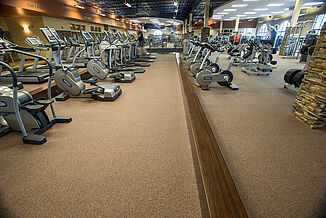 Expansive view of the Team 85 Facility, showcasing cardio equipment, machines and free weights.