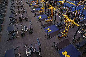 The Michigan football performance center features REGUPOL aktivpro roll inlaid platforms.