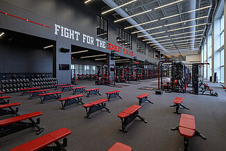 View of the free weight, machines and rack area of the facility. The various equipment is all designed for Texas Tech team pride and to strengthen athletic performance.