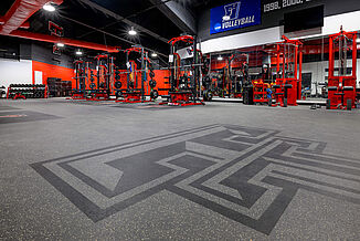 View of the Texas Tech Volleyball weight room flooring, featuring REGUPOL aktivpro roll flooring and custom inlaid rubber logos.