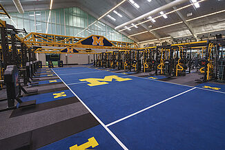 University of Michigan's football performance center with custom colors and logos