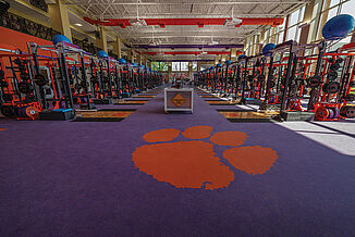 View of the Clemson weight lifting facility, with the Clemson logo inlaid into the REGUPOL flooring.