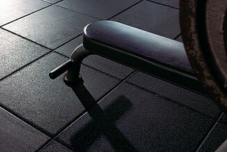 Close-up of a weight bench's legs at Temple University on REGUPOL aktivpro rubber gym floor.