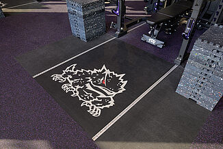 TCU crash inlaid platforms demonstrate the custom logo capabilities offered by REGUPOL flooring.