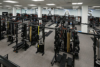 University of Texas at Austin Weight Training - Machine View View of the variety of machines and weights offered to athletes within University of Texas at Austin weight training facility. REGUPOL aktivpro roll and crash are used throughout the facility.