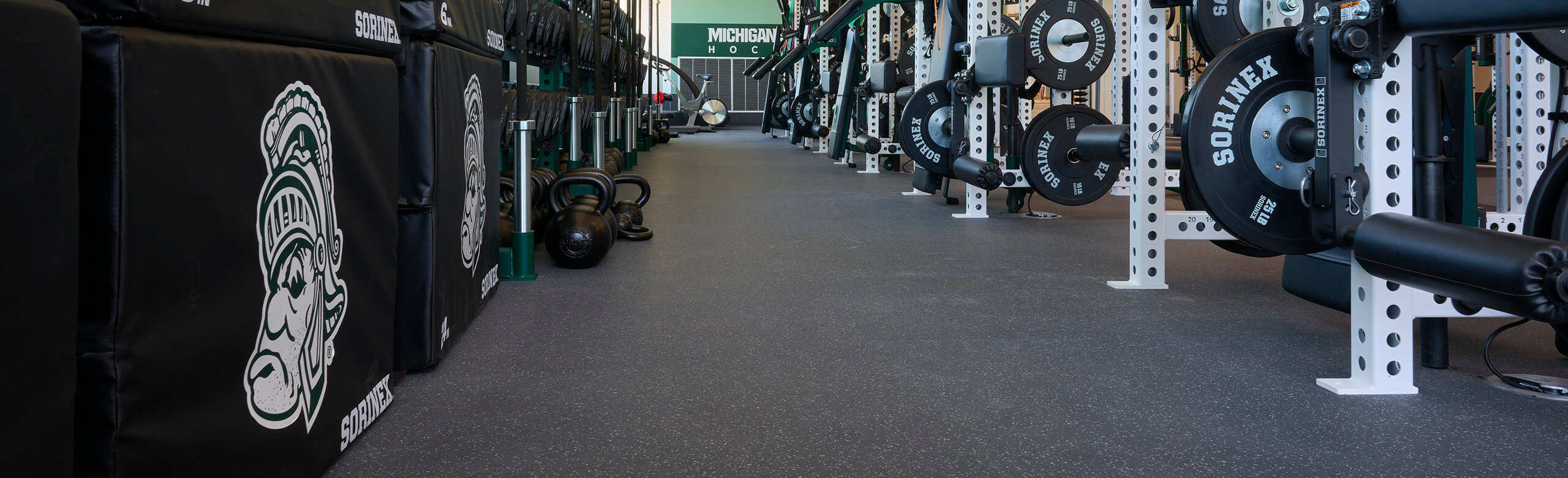 View of Spartan ice hockey weight training facility featuring REGUPOL aktivpro roll flooring, allowing for a seamless floor plan. 