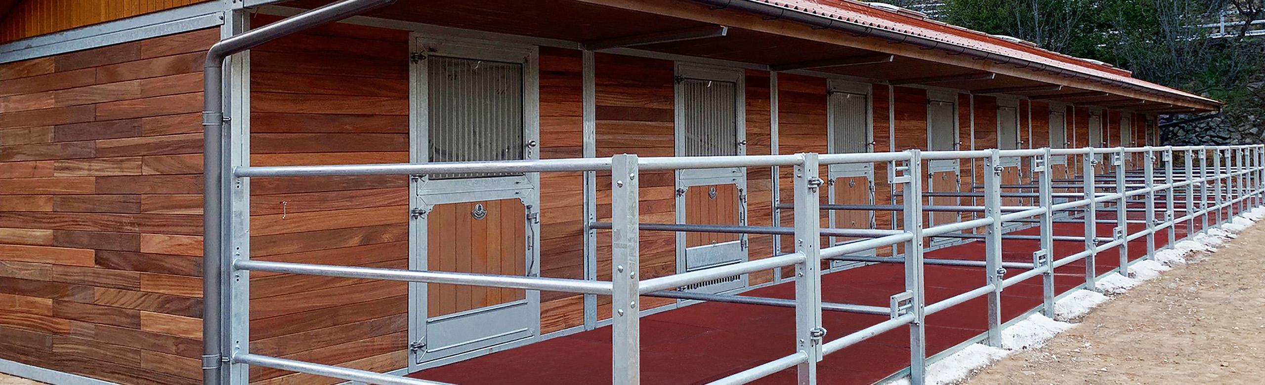 REGUPOL Equestrian Flooring - Paddocks Row of equine paddocks featuring REGUPOL equiline tiles that allow for increased durability, a clean paddock area and enhanced safety.