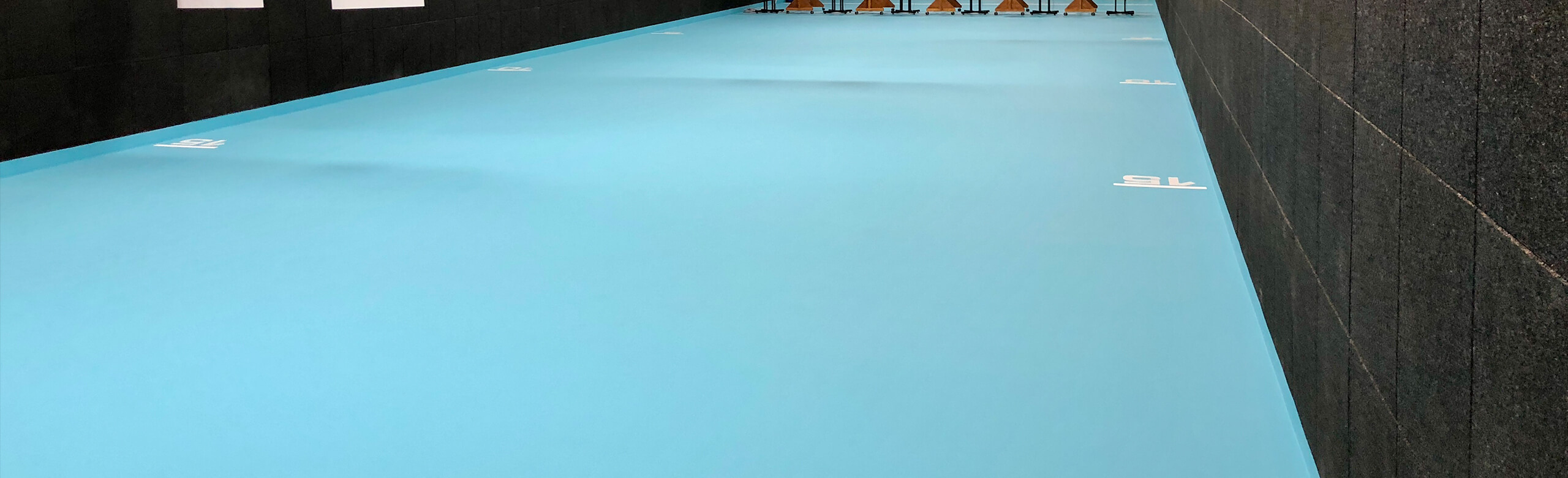 REGUPOL ballistic FH45 safety floor with markings and lines in a shooting range.