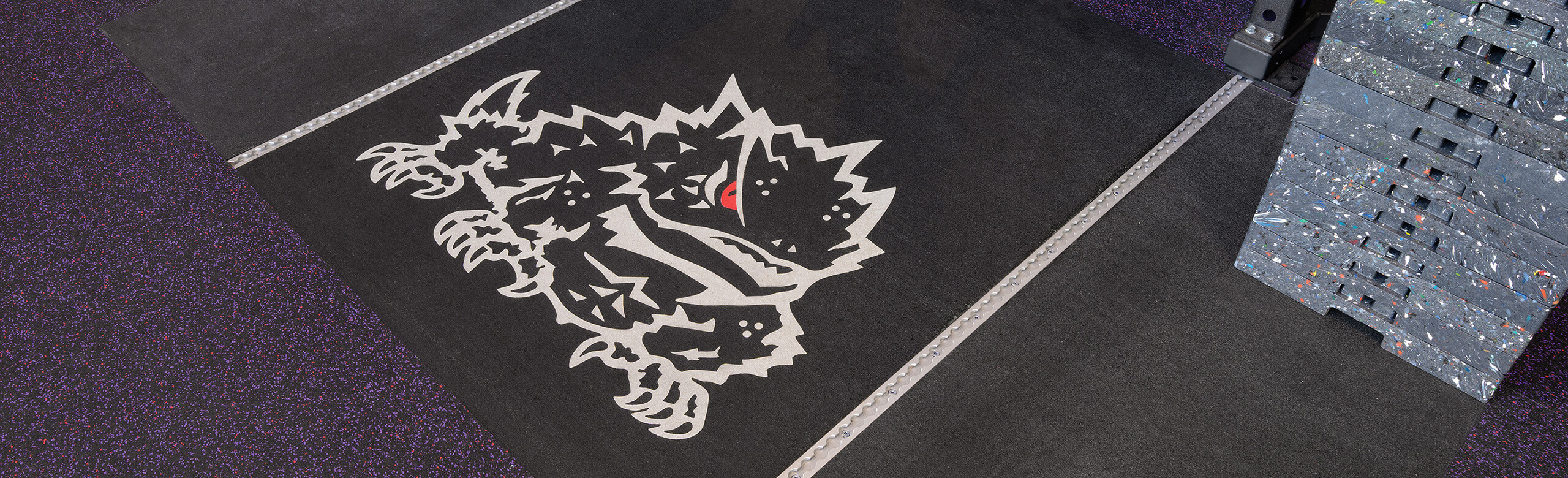 TCU crash inlaid platforms demonstrate the custom logo capabilities offered by REGUPOL flooring.