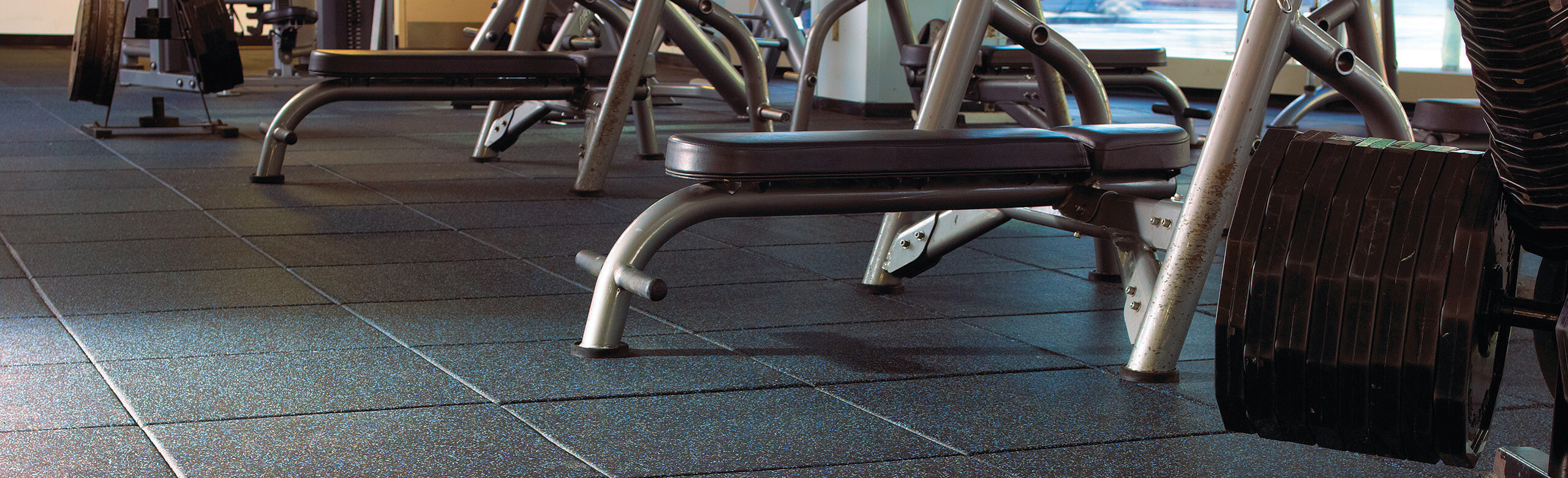 Two weight benches sit on Temple University's REGUPOL aktipro rubber flooring.